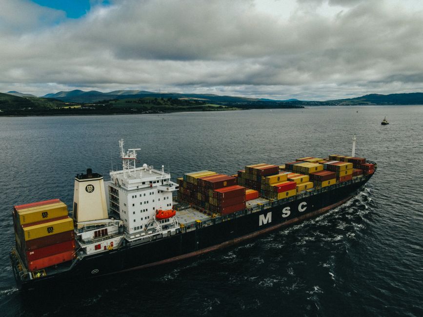 A cargo ship laden with containers sails through the waters near Inverclyde, Scotland.